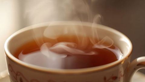 Steaming Porcelain Teacup Ornate Pattern Releasing Warm Steam Closeup Cozy Morning Warmth