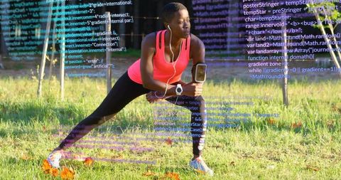 Performing lateral lunge in park wearing smartwatch and earbuds with code overlay