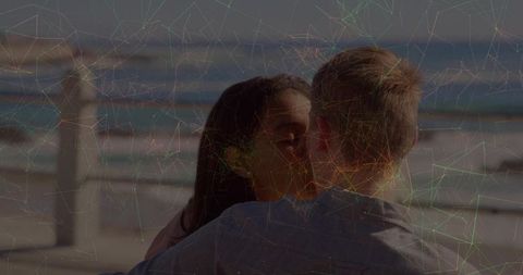 Romantic Couple Embracing at Scenic Beach Promenade