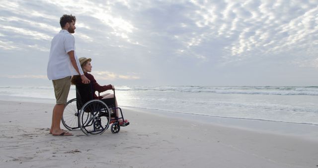 Caregiver and Senior Woman in Wheelchair Enjoying Beach Sunset - Download Free Stock Images Pikwizard.com