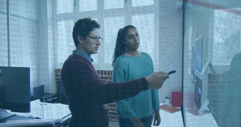 Diverse business professionals analyzing data on transparent display