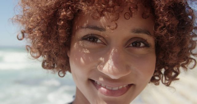 Smiling Woman with Curly Hair Enjoying Sunny Day at Beach - Download Free Stock Images Pikwizard.com