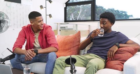 Friends recording podcast in modern relaxed setting