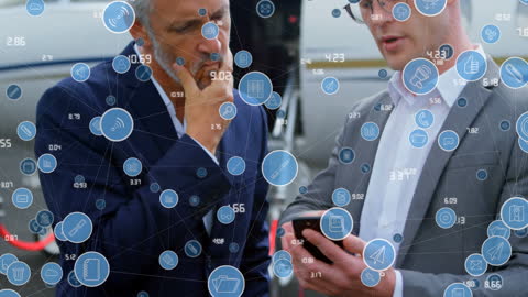 Business Professionals Discussing Technology Concepts at Airport