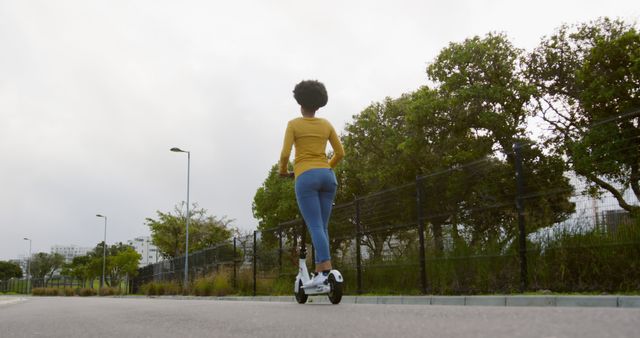 Woman Riding Electric Scooter Outdoor on Urban Road - Download Free Stock Images Pikwizard.com