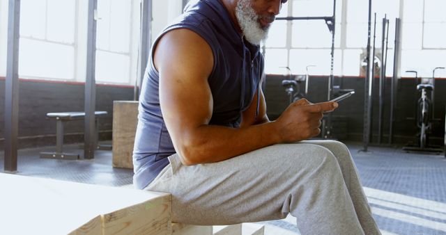 Senior Man Checking Smartphone During Gym Workout - Download Free Stock Images Pikwizard.com