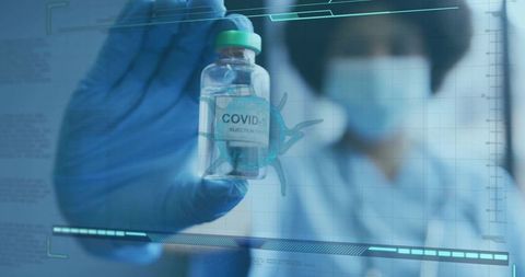 Healthcare Professional Presenting COVID-19 Vaccine Vial with Digital Interface