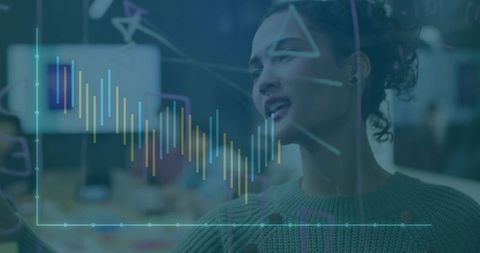 Speaking Woman in Green Sweater Pointing at Holographic Data Chart on Glass in Office
