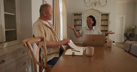 Senior Asian Couple Managing Finances Together at Home