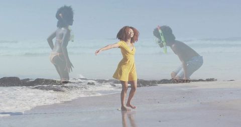 Woman in yellow dress dancing on sunlit beach with translucent snorkeling children overlay