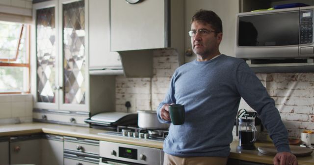 Mature Man Drinking Coffee in Rustic Kitchen Setting - Download Free Stock Images Pikwizard.com