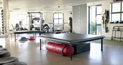Padded training platform in rehab studio center with red recovery bag and foam block