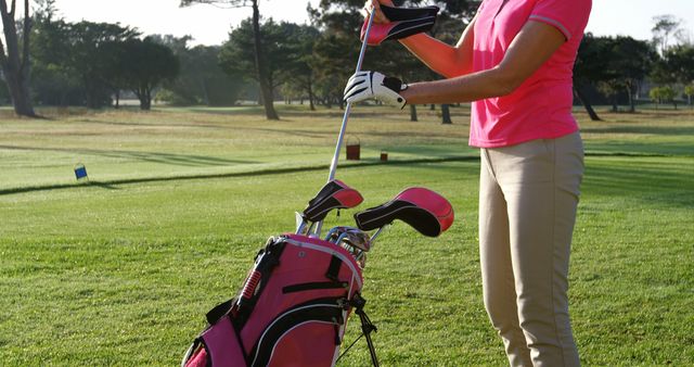 Female Golfer Preparing Club on Green Lawn - Download Free Stock Images Pikwizard.com