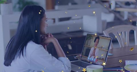 Woman in Home Office Engaging in Virtual Meeting with Colleague