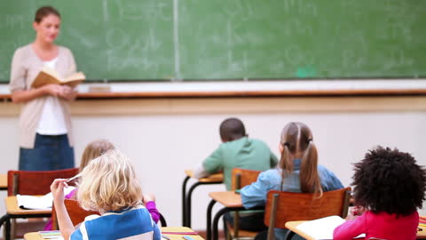 Teacher Reading to Students in Classroom Education Setting
