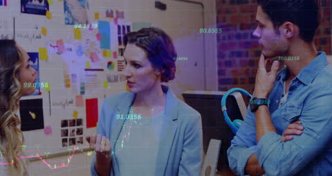 Diverse Colleagues Discussing in Office with Financial Data Overlay