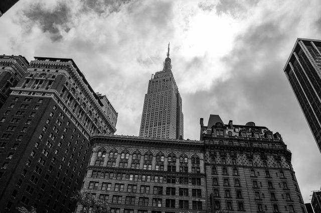 This image captures the iconic skyline of New York City with a focus on its historic and modern skyscrapers, including the Empire State Building. Ideal for use in travel marketing, urban architecture features, tourism brochures, or cultural articles about New York City.