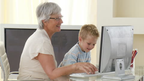 Grandmother and Grandchild Engaging with Home Computer