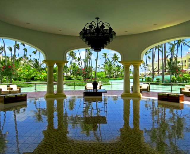 Elegant Open-Air Lobby with Tropical Palm Trees and Reflective Floor - Download Free Stock Photos Pikwizard.com