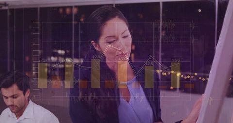 Businesswoman presenting data on flipchart with digital chart overlay in modern office at night