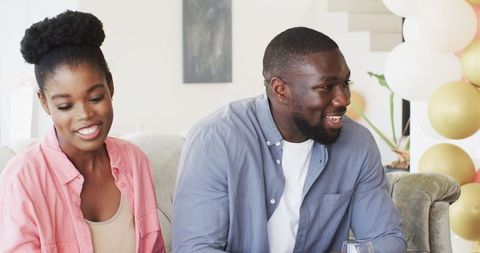 Smiling Couple Celebrating Pregnancy Announcement with Family
