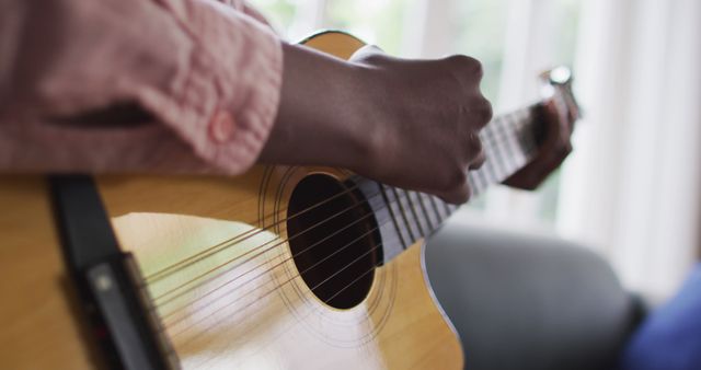 Close up of african american woman playing guitar at home - Download Free Stock Photos Pikwizard.com