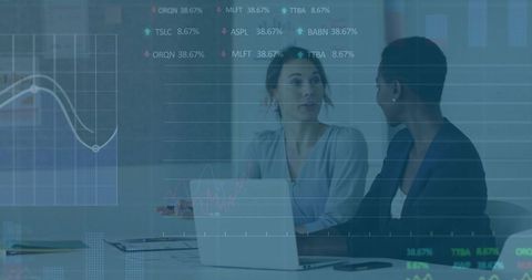 Two Businesswomen Reviewing Financial Analytics on Laptop in Boardroom Collaboration