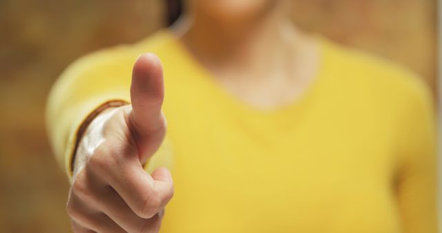 Close-Up of Outstretched Hand Pointing Finger Wearing a Yellow Top - Download Free Stock Images Pikwizard.com