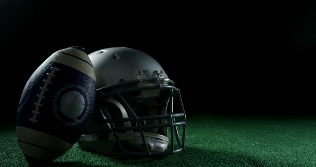American Football Helmet and Ball on Green Turf Ready for Game - Download Free Stock Images Pikwizard.com