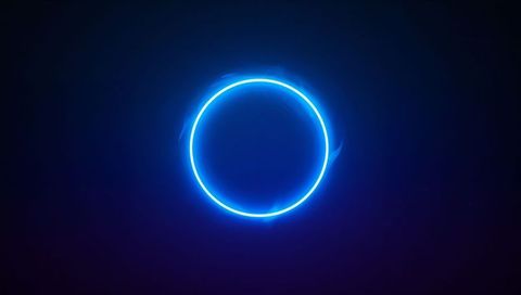 Glowing Neon Blue Ring Emitting Soft Halo and Faint Wisps on Deep Navy Purple Gradient