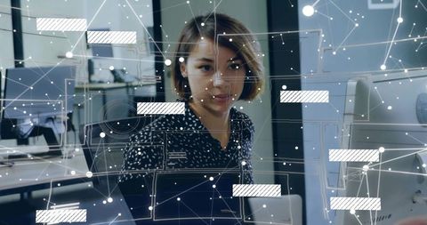 Young woman working with digital network overlay in modern open-plan office