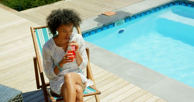 Woman Relaxing by Poolside Enjoying Refreshing Drink on Sunny Day - Download Free Stock Images Pikwizard.com