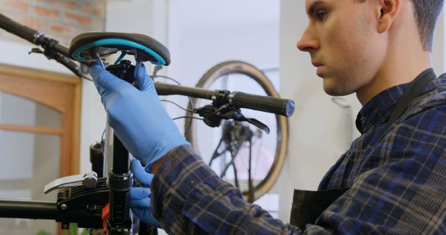 Bicycle Mechanic Adjusting Saddle in Workshop - Download Free Stock Images Pikwizard.com