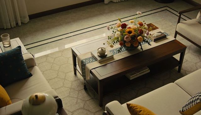 Warm living room coffee table with floral centerpiece and sunflower arrangement