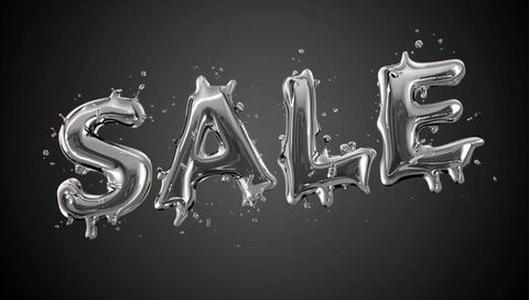 Glinting chrome sale balloons hovering with metallic droplets on dark gray background