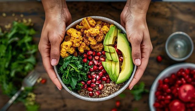 Healthy vegan bowl with cauliflower, avocado, and pomegranate