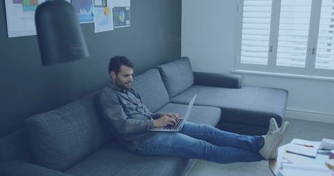 Man Working Comfortably on Laptop in Modern Living Room