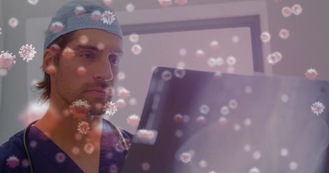 Doctor analyzing x-ray with floating covid-19 cells overlay