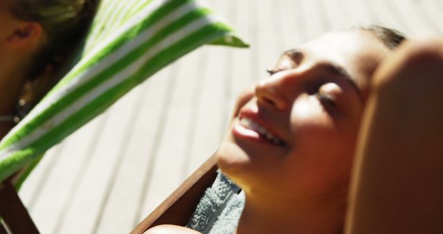 Relaxing in Summer Sun on Striped Deck Chair - Download Free Stock Images Pikwizard.com