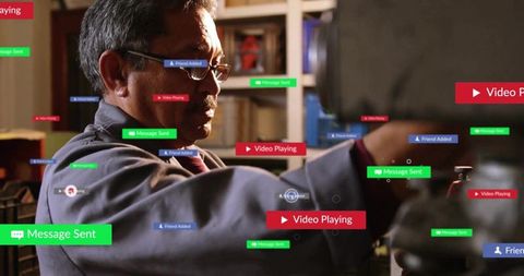 Senior technician using lathe with augmented reality overlays