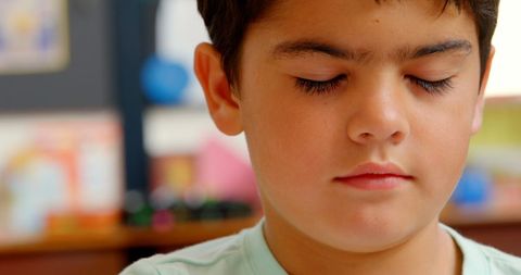 Caucasian Schoolboy Meditating in Classroom - Download Free Stock Images Pikwizard.com