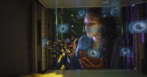 Technician Inspecting Network Cables with Digital Overlays in Data Center