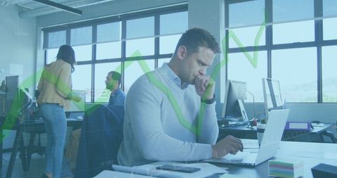Focused businessman analyzing financial data with growth graph