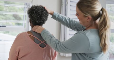 Physiotherapist Treating Senior Woman for Neck Pain