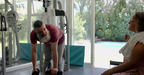Senior Couple Engaging in Exercise Routine at Home Gym