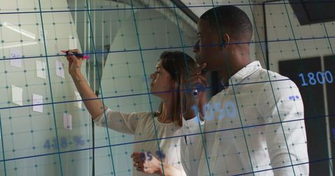 Business Professionals Analyzing Data on Interactive Board