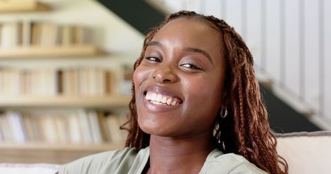 Smiling Woman Relaxing on Comfortable Sofa at Home