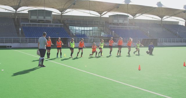 Field Hockey Players Practicing on Sunny Day with Coach - Download Free Stock Images Pikwizard.com