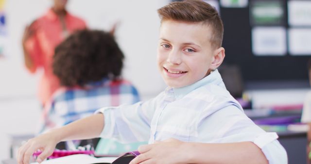 Boy smiling while participating in a classroom setting, adding a sense of lively and engaging learning environment. Suitable for educational themes, school promotions, classroom activities, student engagement, and happy learning moments.