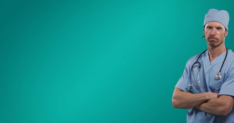 Professional Doctor in Scrubs with Arms Crossed on Green Background